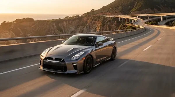 Nissan GT-R supercar driving along a highway during golden hour.